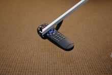 Charger l&#39;image dans la galerie, Reach-N-Grip picking up a TV remote control
