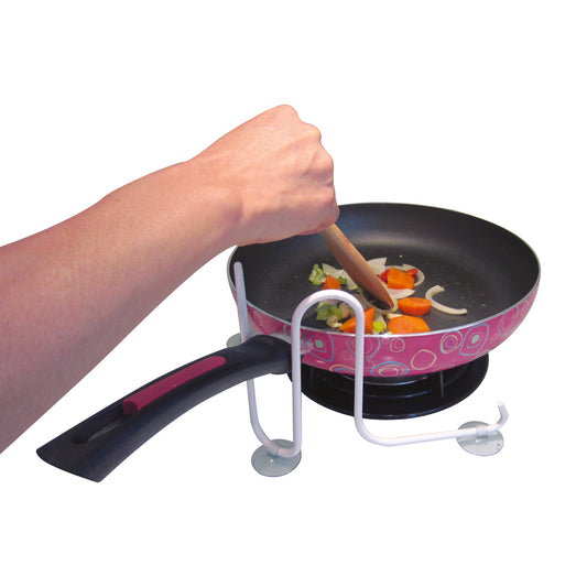 pot and pan holder in use on a stove holding a pan
