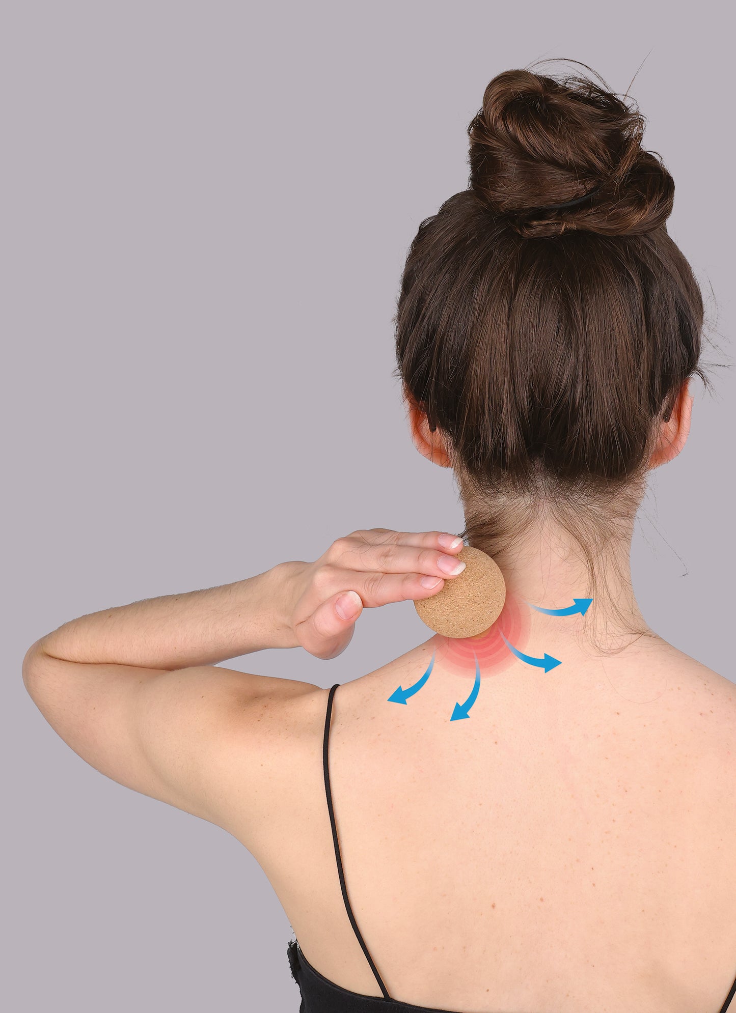back view of a person using the cork ball on the back of their neck