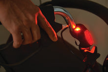 Load image into Gallery viewer, LED light on a bake handle of a walker lit up in red
