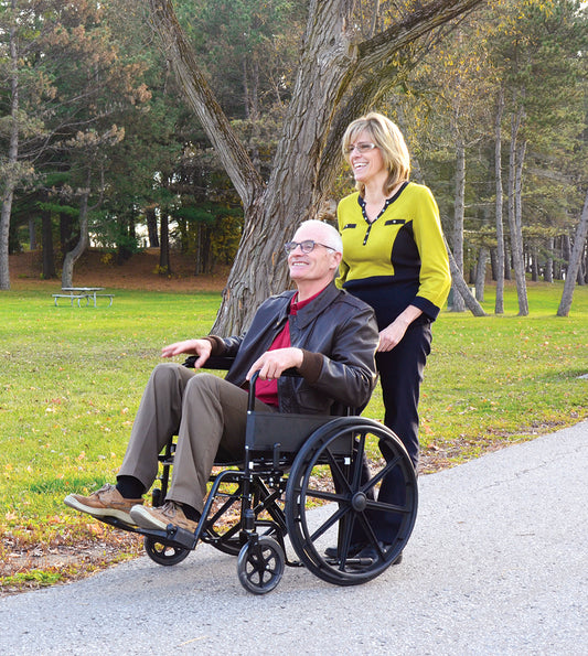Woman pushing man in 56084 Wheelchair